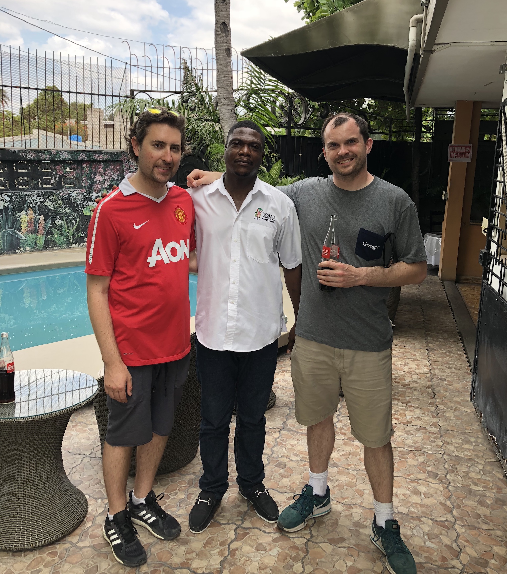 Me, James, and another Wall House survivor at the site of the earthquake in 2018. The palm tree in the background is the one James jumped into.